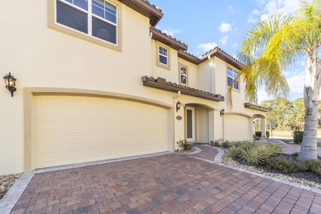 mediterranean / spanish-style home with a garage