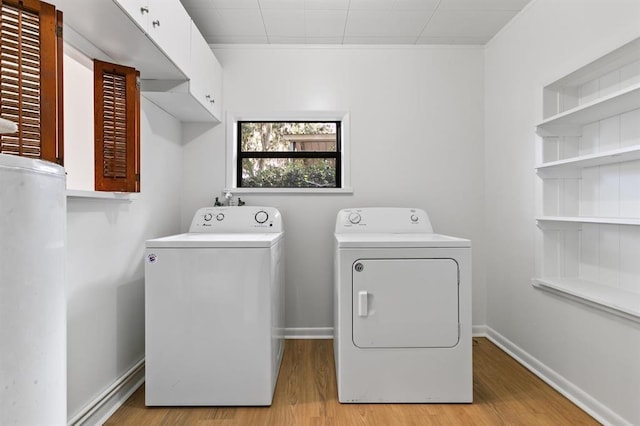 laundry area with separate washer and dryer, laundry area, and light wood finished floors