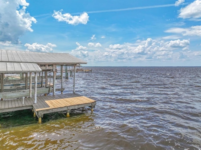 dock area featuring boat lift and a water view