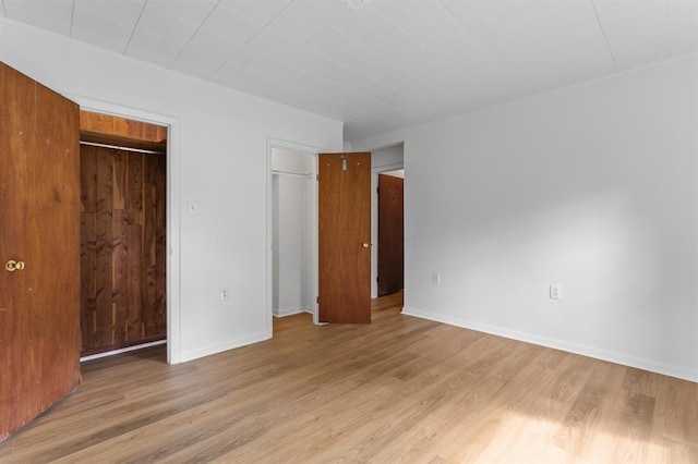 unfurnished bedroom featuring baseboards and light wood finished floors