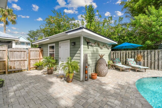 view of outbuilding featuring a fenced in pool