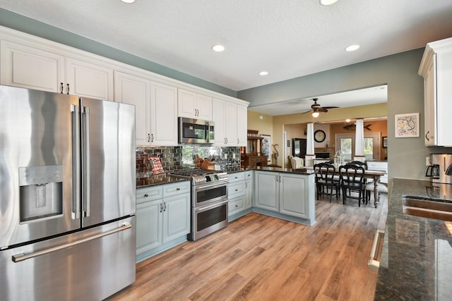 137 Twine St, Saint Augustine, FL 32084 - kitchen featuring stainless steel appliances, a ceiling fan, light wood-style floors, a peninsula, and tasteful backsplash