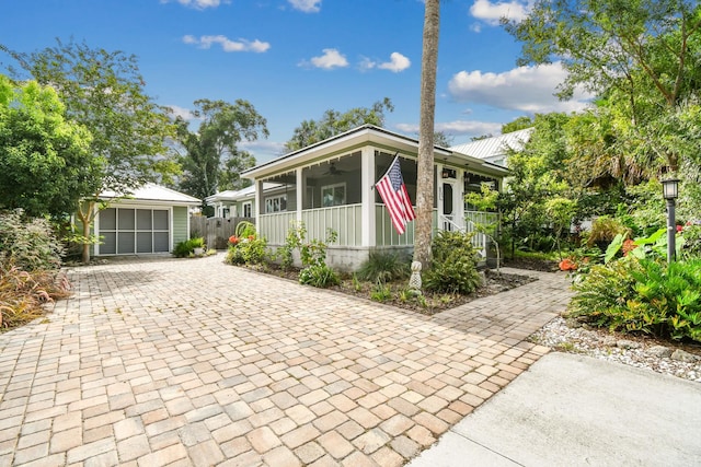 bungalow-style home featuring ceiling fan, an outdoor structure, and a garage