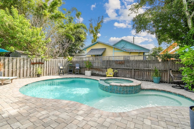 view of pool with an in ground hot tub and a patio area