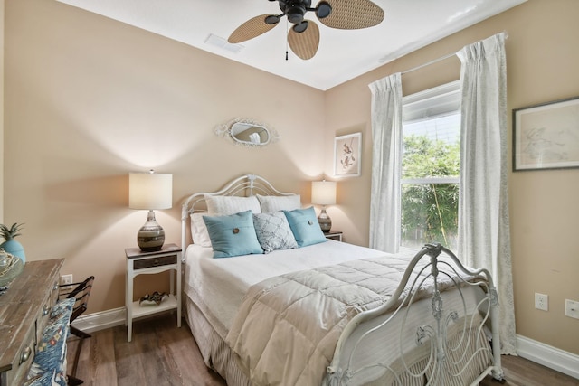 bedroom with ceiling fan and dark hardwood / wood-style floors