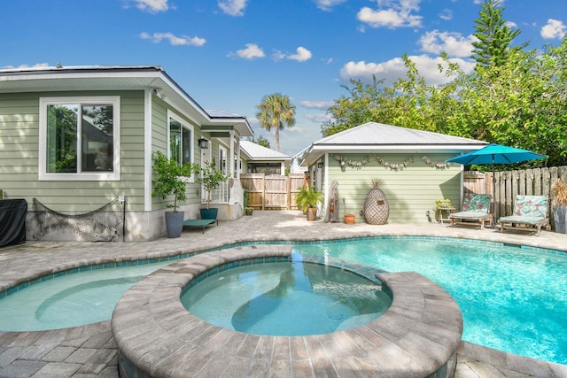 view of pool with an in ground hot tub