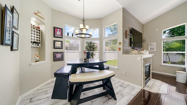 700 N Indigo Ter, Saint Johns, FL 32259 - dining area featuring a chandelier, wood finished floors, baseboards, and a fireplace with flush hearth