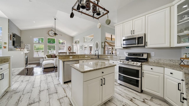700 N Indigo Ter, Saint Johns, FL 32259 - kitchen with stainless steel appliances, a sink, a peninsula, light wood-type flooring, and white cabinetry