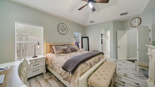 700 N Indigo Ter, Saint Johns, FL 32259 - bedroom featuring arched walkways, light wood-style flooring, a raised ceiling, and a ceiling fan