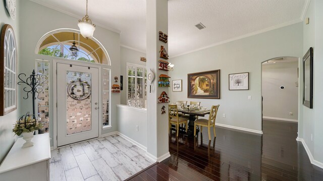 700 N Indigo Ter, Saint Johns, FL 32259 - entrance foyer featuring ornamental molding, baseboards, wood finished floors, and arched walkways