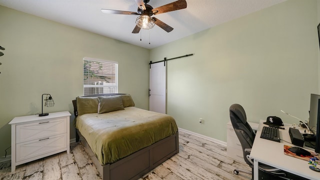 700 N Indigo Ter, Saint Johns, FL 32259 - bedroom with a barn door, an office area, baseboards, light wood finished floors, and ceiling fan