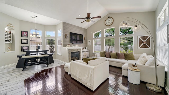 700 N Indigo Ter, Saint Johns, FL 32259 - living room with a ceiling fan, high vaulted ceiling, a glass covered fireplace, a chandelier, and hardwood / wood-style floors