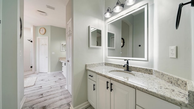 700 N Indigo Ter, Saint Johns, FL 32259 - bathroom featuring vanity, wood finished floors, and baseboards