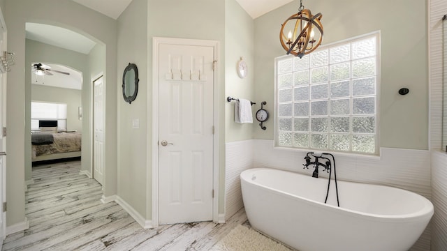 700 N Indigo Ter, Saint Johns, FL 32259 - full bathroom with a freestanding bath, ensuite bath, wood finished floors, a chandelier, and a ceiling fan