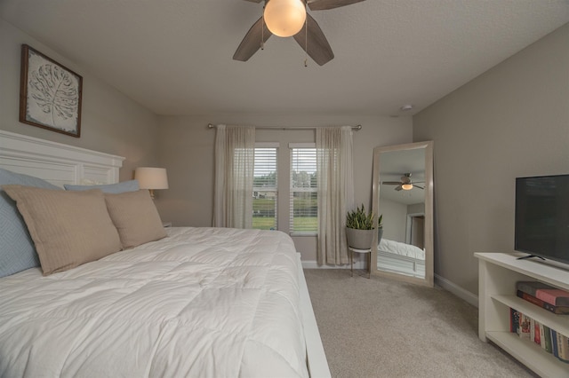 bedroom featuring light colored carpet and ceiling fan