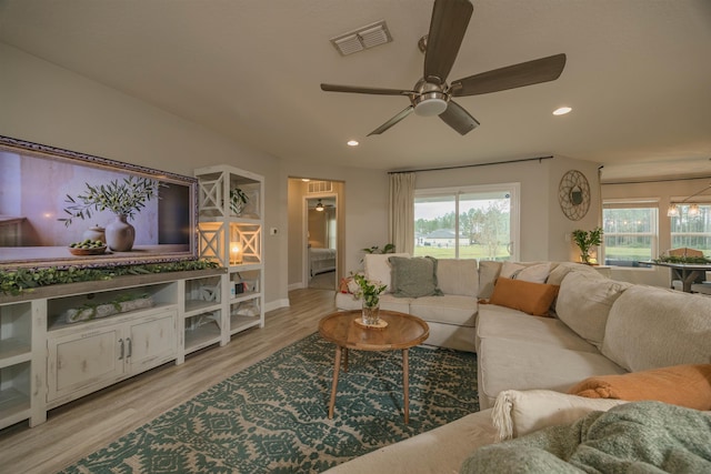 living room with ceiling fan and light hardwood / wood-style floors