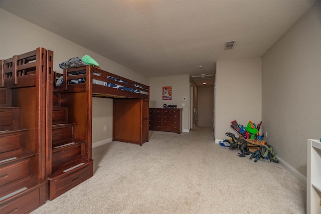 carpeted bedroom featuring a textured ceiling