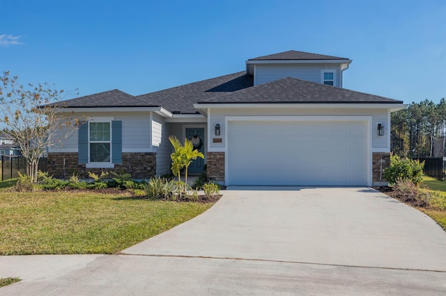 view of front of property with a garage and a front yard