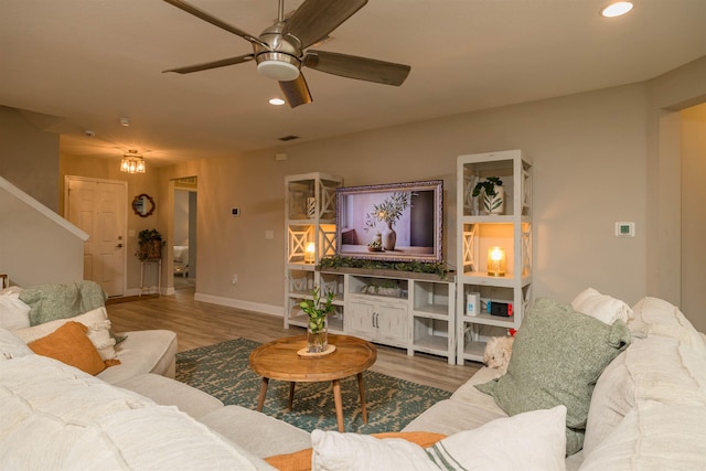 living room featuring hardwood / wood-style floors and ceiling fan