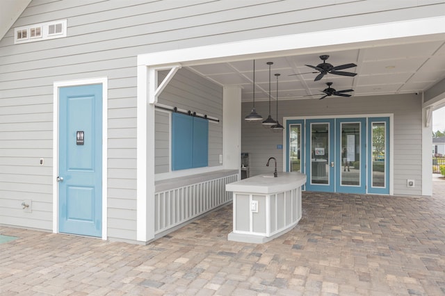 view of patio / terrace featuring sink and ceiling fan