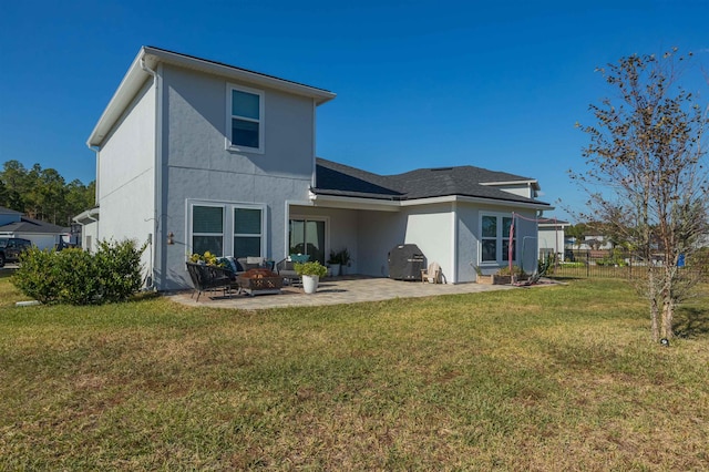 back of property with a yard and a patio area