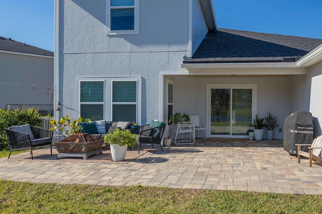 back of house with a patio area and a fire pit