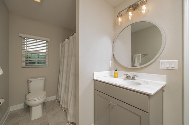 bathroom featuring tile patterned flooring, vanity, and toilet