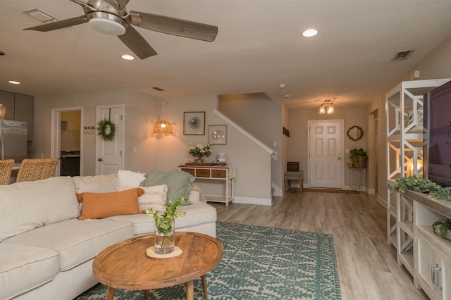 living room with ceiling fan and light hardwood / wood-style floors