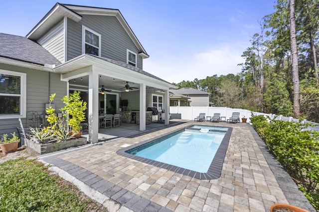 rear view of property with a shingled roof, ceiling fan, a fenced backyard, a fenced in pool, and a patio area