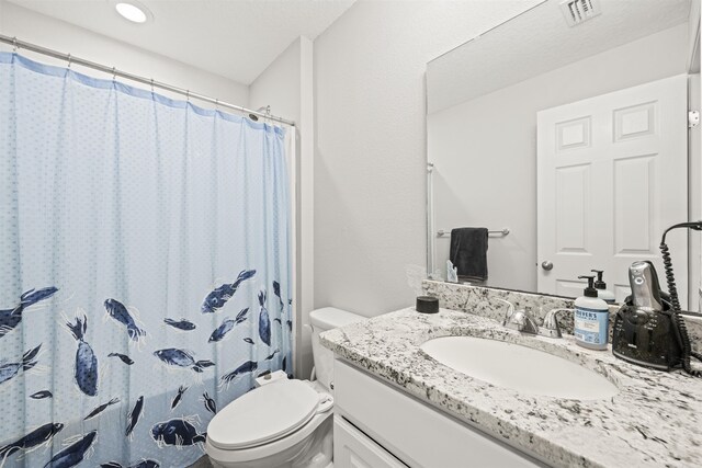 full bathroom with vanity, toilet, and visible vents