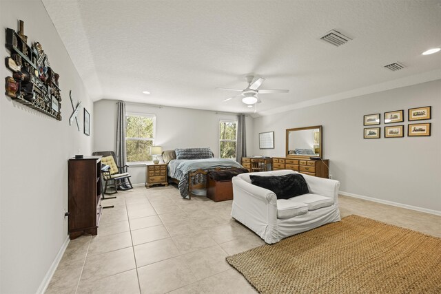 bedroom featuring a textured ceiling, ceiling fan, light tile patterned floors, and visible vents