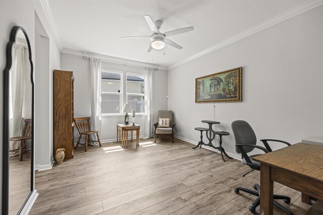 office space with ceiling fan, ornamental molding, light wood-type flooring, and a textured ceiling