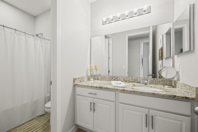 full bathroom with toilet, tile patterned floors, shower / tub combo, and vanity