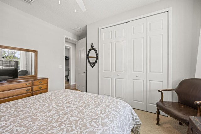 bedroom featuring a closet, a ceiling fan, and carpet