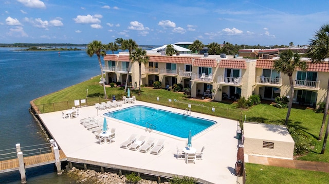 view of pool featuring a water view and a patio area