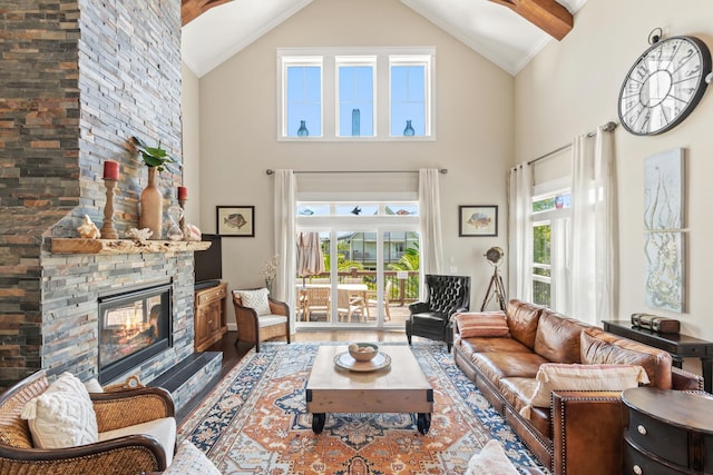 living room with a fireplace, hardwood / wood-style flooring, and vaulted ceiling with beams