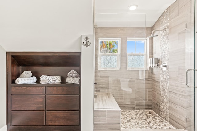 bathroom featuring a shower with shower door