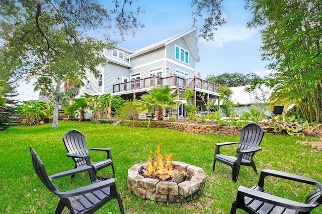 view of yard with a deck and an outdoor fire pit