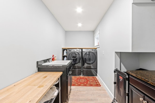 washroom featuring sink, independent washer and dryer, and wood-type flooring