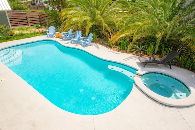 view of pool with an in ground hot tub