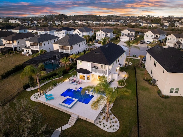 aerial view at dusk featuring a residential view