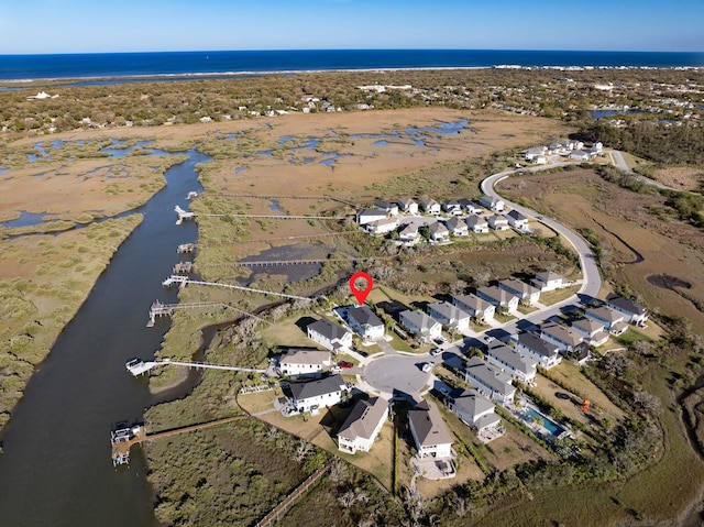 birds eye view of property with a water view and a residential view