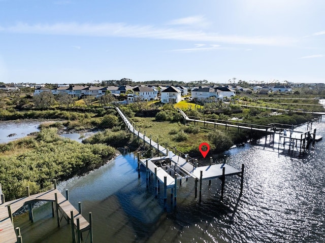 birds eye view of property with a water view and a residential view