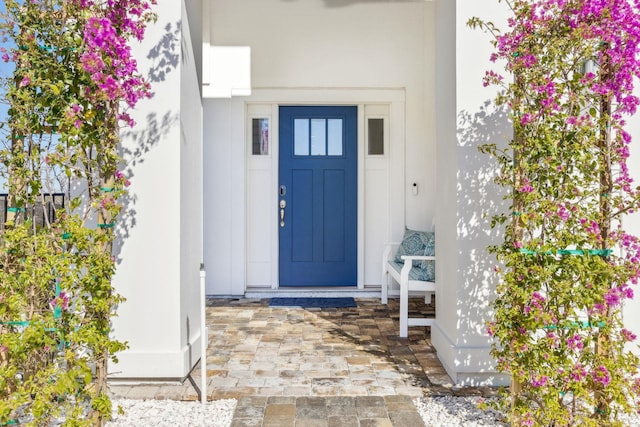 entrance to property with stucco siding