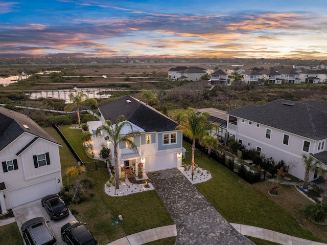 aerial view at dusk featuring a residential view