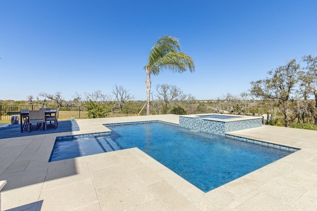 view of swimming pool with a pool with connected hot tub, a patio, and fence