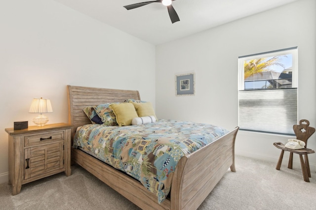 bedroom featuring ceiling fan, baseboards, and light carpet