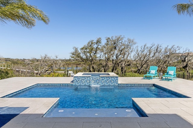 view of swimming pool with a patio and a pool with connected hot tub