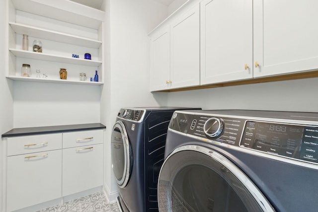 clothes washing area with cabinet space and separate washer and dryer