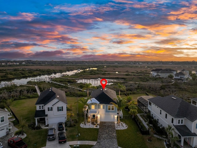 aerial view at dusk with a water view